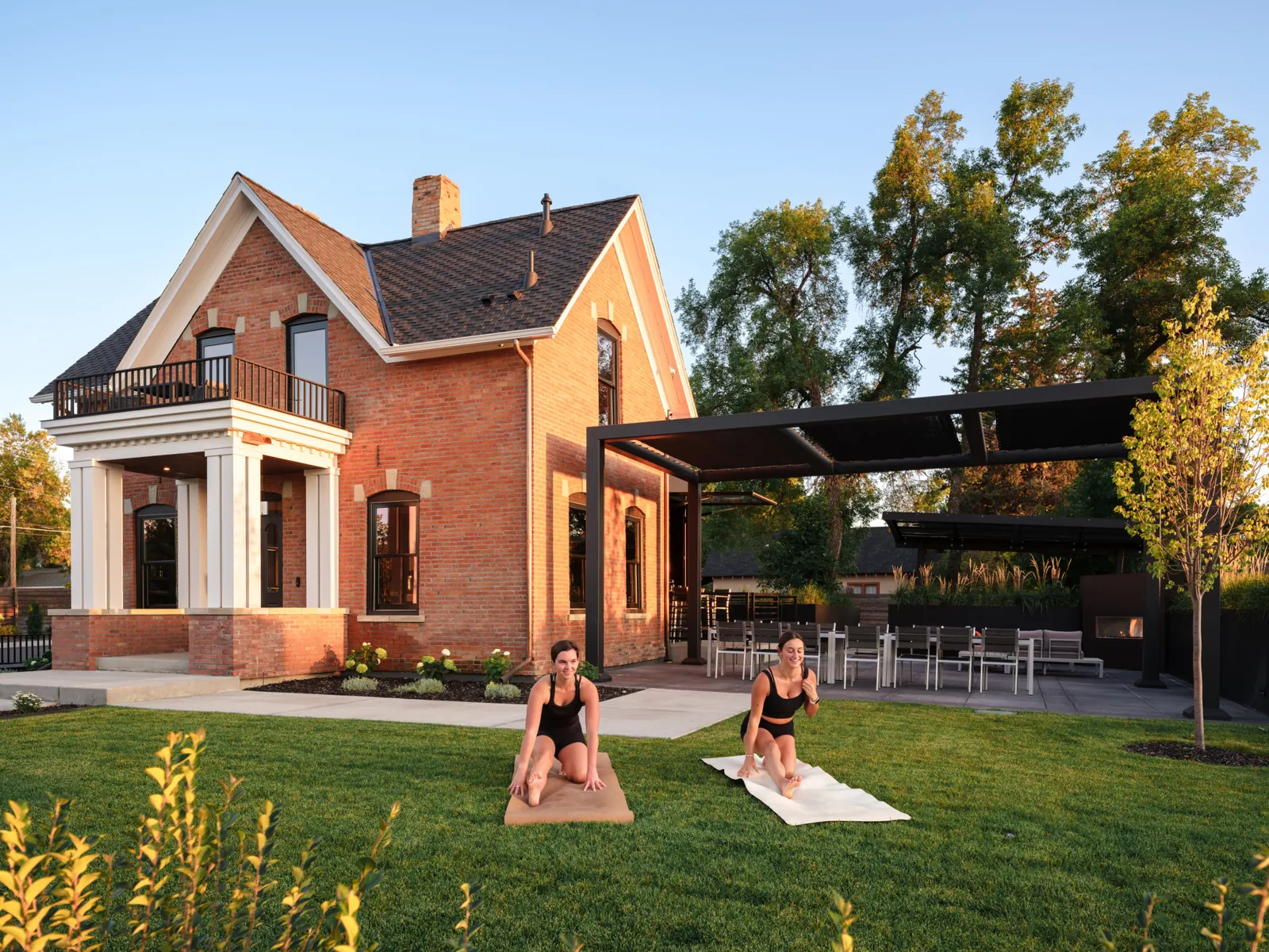 Guests practicing yoga on the lawn outside Rouse House