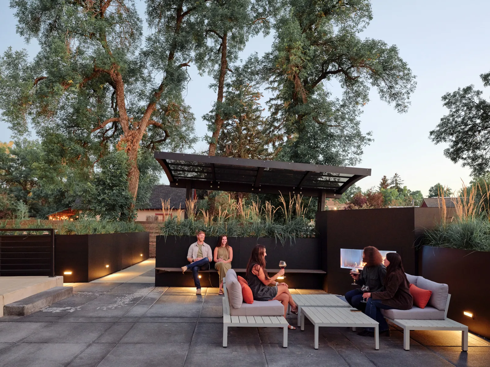 Guests relaxing on the estate terrace at dusk