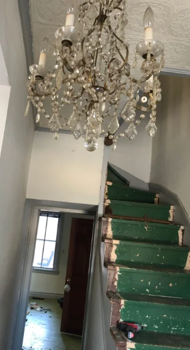 Original staircase and chandelier before restoration